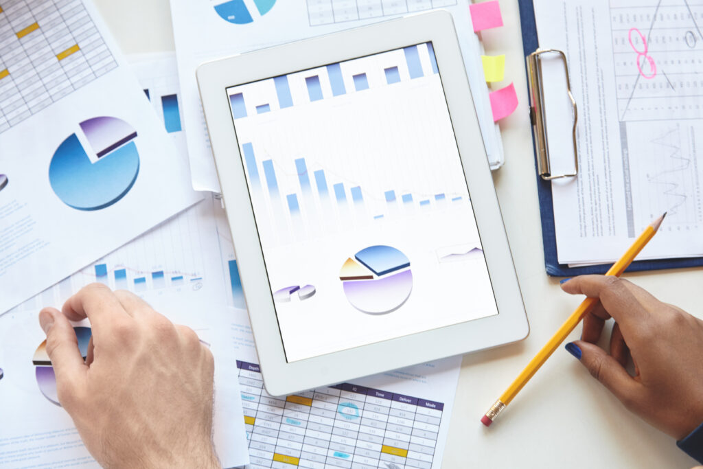 Business, analysis and strategy. Close-up of touch pad with charts and diagrams on screen. Businesspeople using tablet for discussing financial data, planning, developing new vision for their company